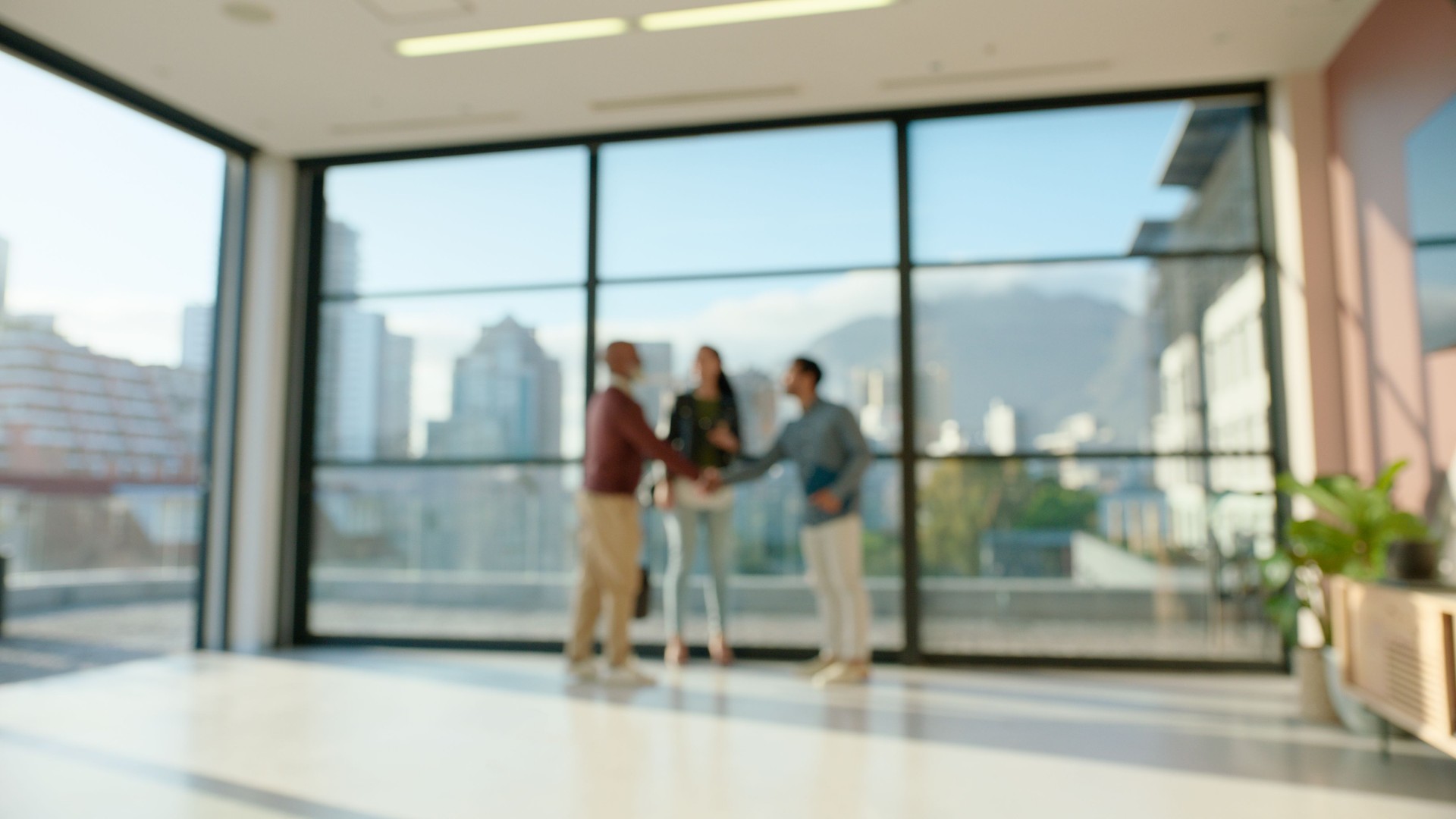 Teamwork, handshake and blur of business people in office for collaboration, agreement and b2b networking. Corporate, window and men and women shaking hands for welcome, thank you and recruitment